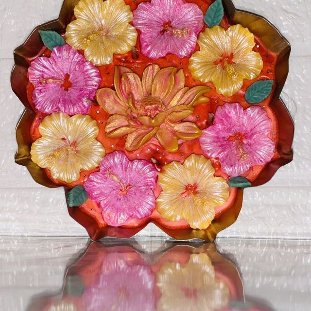 DH-06: Pink and yellow hibiscus around a lotus, in a scalloped metal tray, standing upright.