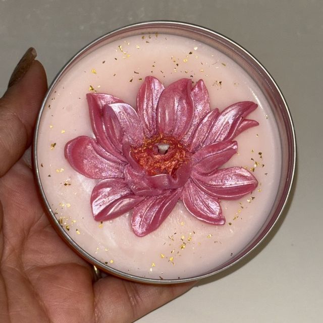 DH-14: A pink lotus on blush wax, in a metal tin, held in a hand, to show its size.