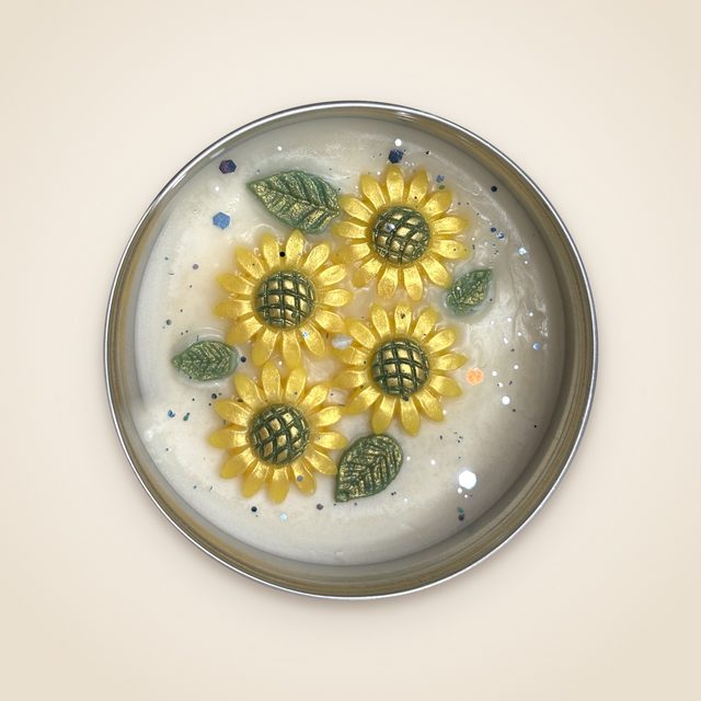 DH-15: Four sunflowers on ivory wax, in a metal tin.