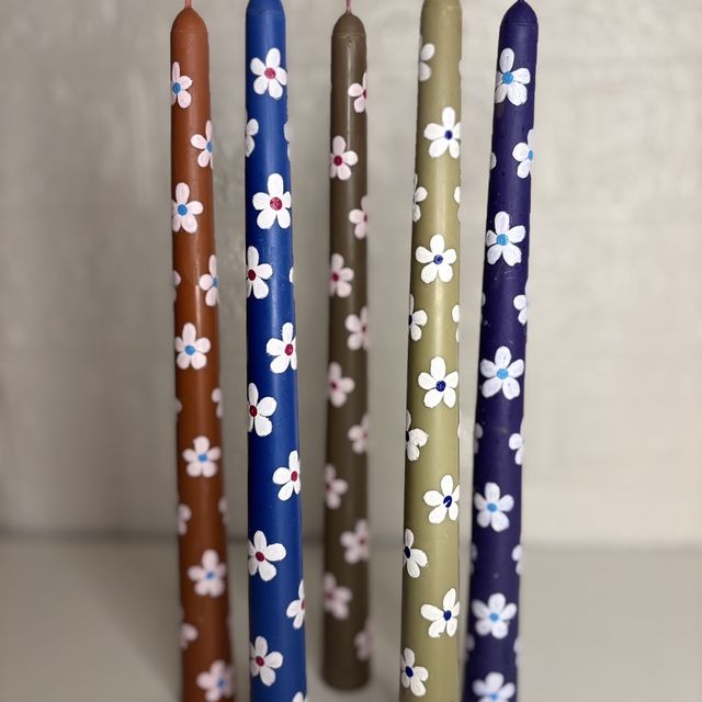 DH-18: Five hand-painted taper candles with little white flowers, all five together.